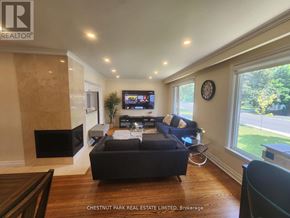 Toronto (Bayview Village) apartment for rent - A living room with a dark sofa and a flat screen TV.