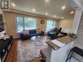 Toronto (Bayview Village) apartment for rent - A living room with a couch, a coffee table, and a clock on the wall.