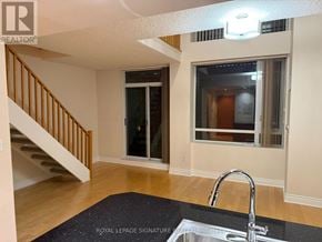 Toronto (Annex) condo for rent - A room with a Royal LePage sign on the floor.