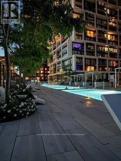 Toronto (Mount Pleasant West) condo for rent - A pool in a city setting surrounded by buildings.