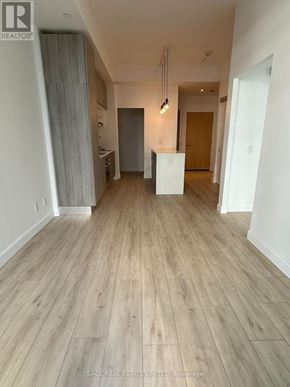 Toronto (Mount Pleasant West) condo for rent - A room with wooden flooring and white walls.