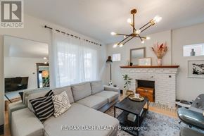 Toronto (Woodbine-Lumsden) apartment for rent - A living room with a grey couch and a fireplace.