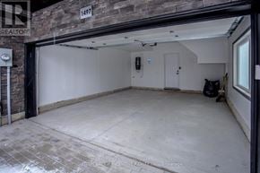Innisfil (Lefroy) townhouse for rent - A garage with a brick wall and a door that is open.
