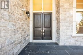 King (Nobleton) apartment for rent - A door with a glass window is in front of a stone wall.