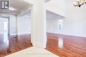 King (Nobleton) apartment for rent - A room with wooden floors and white walls, with a chandelier hanging from the ceiling.