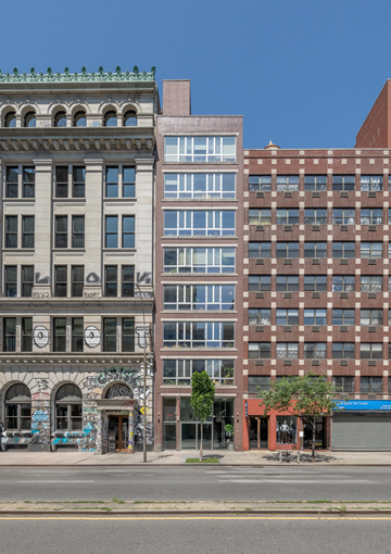 New York apartment for rent - A row of buildings with a blue sky in the background.