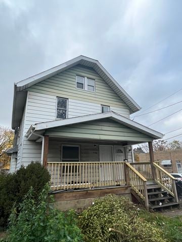 Akron apartment for rent - A house with a porch and a window with a view of the sky.