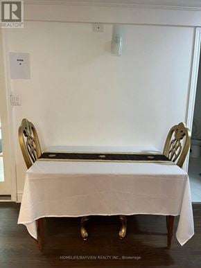 Toronto (Willowdale East) apartment for rent - A white tablecloth is draped over a wooden table with two gold chairs on either side.