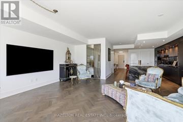 Toronto (Waterfront Communities) condo for rent - A living room with a black screen tv and a black and white sofa.