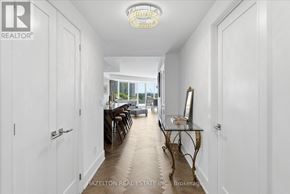 Toronto (Waterfront Communities) condo for rent - A hallway with a table and chairs on the right side.