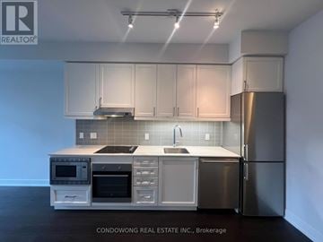 Toronto (Bayview Village) condo for rent - A kitchen with white cabinets and stainless steel appliances.