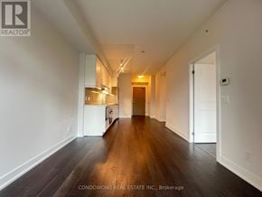 Toronto (Bayview Village) condo for rent - A long hallway with a white door at the end.