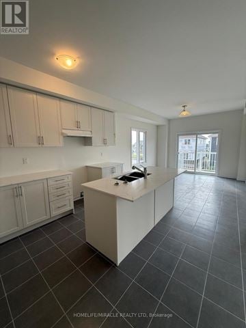 Loyalist (Bath) apartment for rent - A kitchen with white cabinets and a large island.