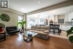 Waterloo apartment for rent - A living room with a black chair, a grey sofa, and a glass coffee table.