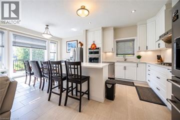 Waterloo apartment for rent - A kitchen with white cabinets and black chairs.