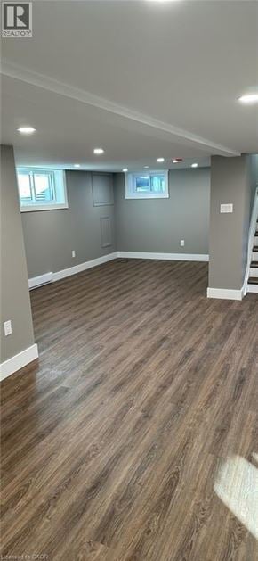 Hamilton apartment for rent - A room with wooden flooring and a staircase on the right side.