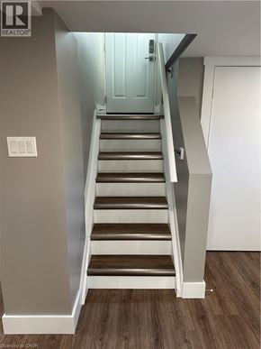 Hamilton apartment for rent - A staircase with a light switch on the wall.