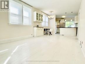 St. Catharines (Port Dalhousie) apartment for rent - A white kitchen with a large island in the middle.
