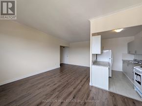 Toronto (Parkwoods-Donalda) condo for rent - A room with wooden flooring and a kitchenette in the corner.