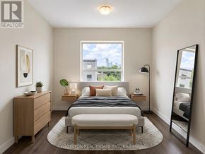 Toronto (Parkwoods-Donalda) condo for rent - A bedroom with a bed, nightstand, and a window with a view of the city.