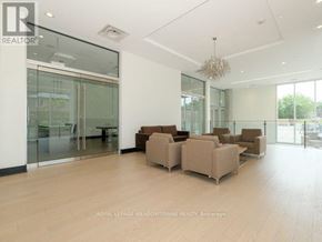Toronto (Woodbine Corridor) condo for rent - A spacious living room with a glass door and a chandelier.