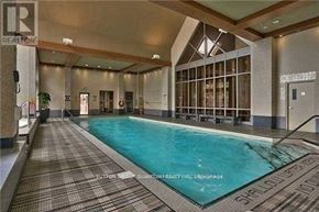 Mississauga (City Centre) condo for rent - A large indoor swimming pool with a tiled floor and walls.