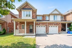 Milton (Wi Willmott) townhouse for rent - A large, two-story house with a brick facade and a white garage door.