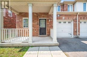 Milton (Wi Willmott) townhouse for rent - A house with a black door and white garage doors.