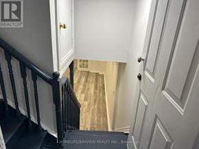 Vaughan (Maple) apartment for rent - A staircase with a black railing and white walls.