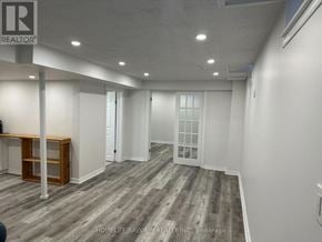 Vaughan (Maple) apartment for rent - A room with a wooden floor and white walls.