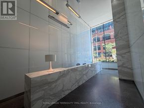 Toronto (Moss Park) condo for rent - A marble bench with a lamp on it in a hallway.