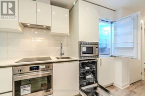 Toronto (Kensington-Chinatown) condo for rent - A kitchen with a stainless steel oven and white cabinets.