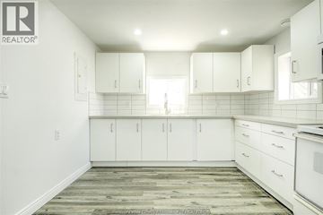 Windsor apartment for rent - A kitchen with white cabinets and a wooden floor.