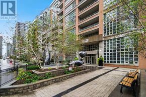 Toronto (Niagara) condo for rent - A modern building with a glass facade and a sculpture in front of it.