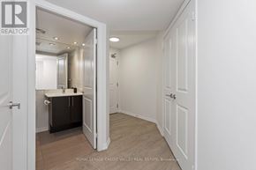 Toronto (Niagara) condo for rent - A white door is open to a room with a mirror and a cabinet.