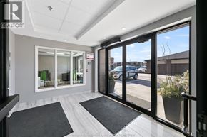 Tecumseh condo for rent - A realtor's office with a view of the street outside.