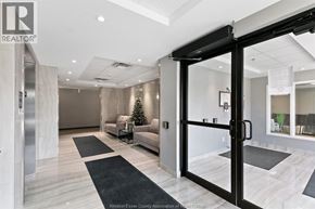 Tecumseh condo for rent - A modern living room with a Christmas tree in the corner.