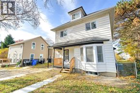 Windsor apartment for rent - A two-story house with a deck and a fence in front.