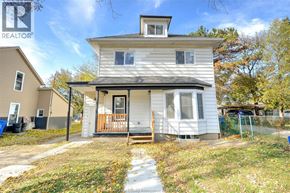 Windsor apartment for rent - A two-story house with a porch and a small front yard.