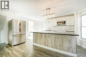 Windsor apartment for rent - A modern kitchen with a wooden island and stainless steel appliances.