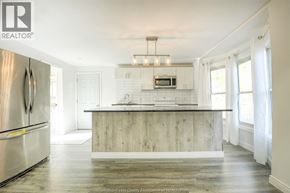 Windsor apartment for rent - A modern kitchen with a wooden island and stainless steel appliances.