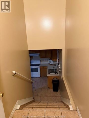Windsor apartment for rent - A hallway with a staircase leading to a kitchen.