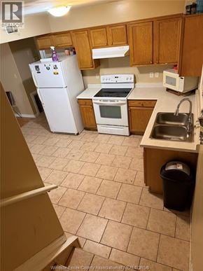Windsor apartment for rent - A kitchen with a white refrigerator, white stove, and white microwave.