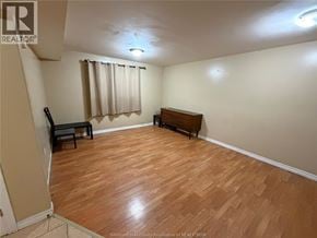 Windsor apartment for rent - A room with wooden flooring and a bench.