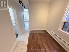 Toronto (North Riverdale) apartment for rent - A room with a wooden floor and white walls.