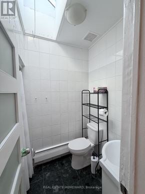 Toronto (North Riverdale) apartment for rent - A white bathroom with a toilet, sink, and a towel rack.