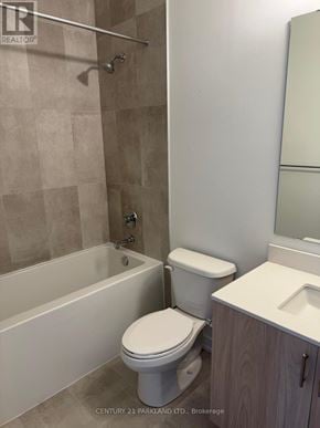Richmond Hill (Devonsleigh) condo for rent - A white toilet sits next to a bathtub in a bathroom.