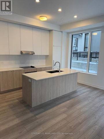 Richmond Hill (Devonsleigh) condo for rent - A kitchen with wooden cabinets and a countertop.
