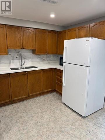 Brampton (Bram West) apartment for rent - A white refrigerator in a kitchen with wooden cabinets.