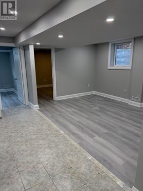 Brampton (Bram West) apartment for rent - A room with grey walls and wooden flooring.